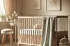 DALL·E 2024-11-23 00.00.21 – A calming and cozy bedroom scene with a stylish baby crib. The crib should be designed with safety in mind, featuring secure bars and soft, pastel bed